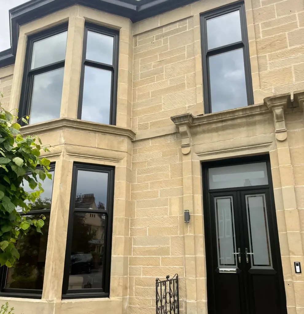 uPVC sliding sash windows on a sandstone Glasgow tenement