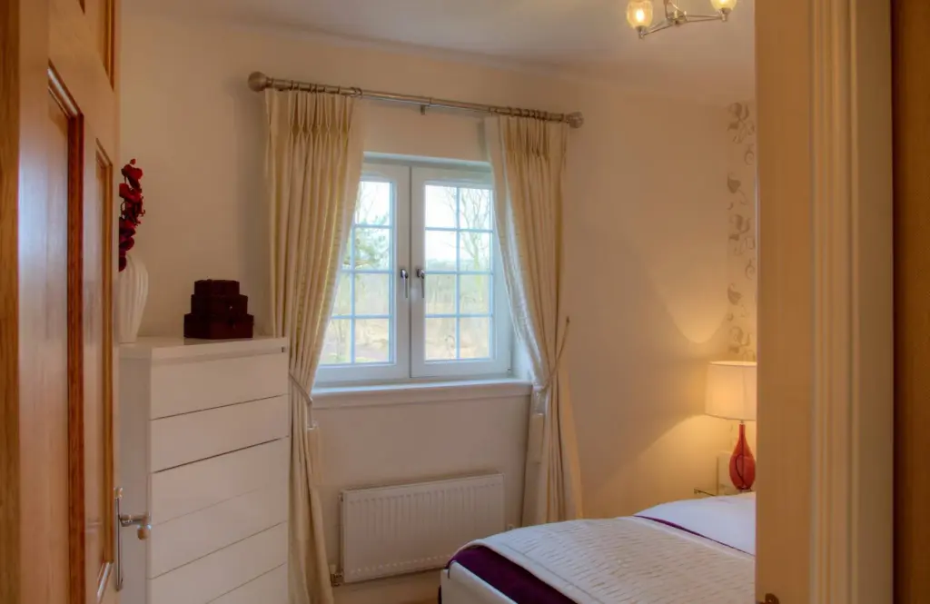 White uPVC double-glazed windows viewed from inside a bedroom