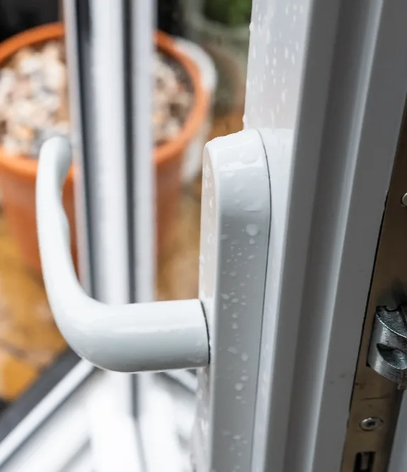 Close view of the handle and frame on a white uPVC window